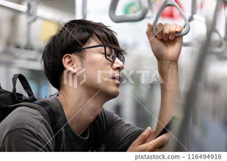 Tired man riding on the train 116494916