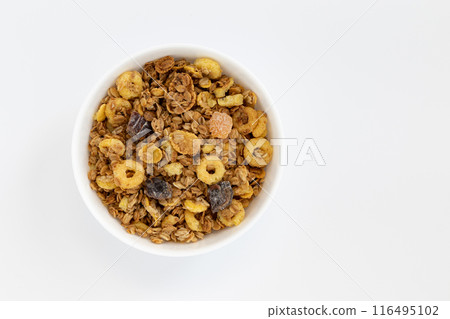 crunchy granola in bowl isolated on white background 116495102