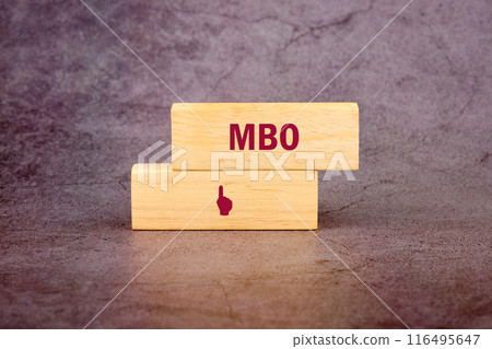 The letters MBO It is an abbreviation for Management by Objectives. MBO on wooden blocks on an abstract background 116495647
