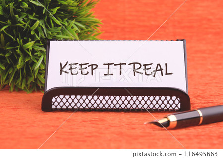 Beautiful background. Business concept. The words KEEP IT REAL on a white business card and a stand 116495663