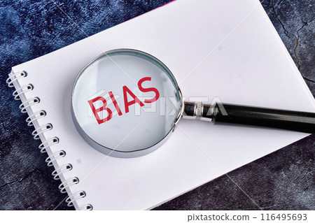 Personal opinions prejudice bias concept. BIAS through a magnifying glass on a blank piece of notebook 116495693