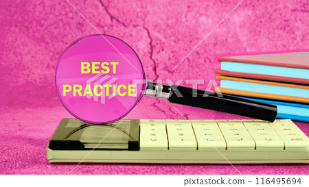 Conceptual best practice symbol. Copy space. Best practice words written through a magnifying glass standing on a calculator in bright colors 116495694