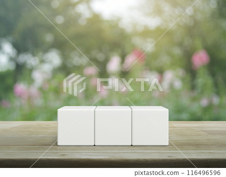 Three white block cubes on wooden table 116496596