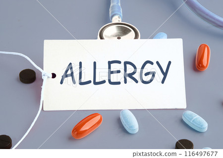 ALLERGY word on a white card on a gray background. Concept photo 116497677