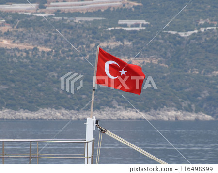 The flag of Turkey flutters in the wind on the deck of pleasure yacht. 116498399