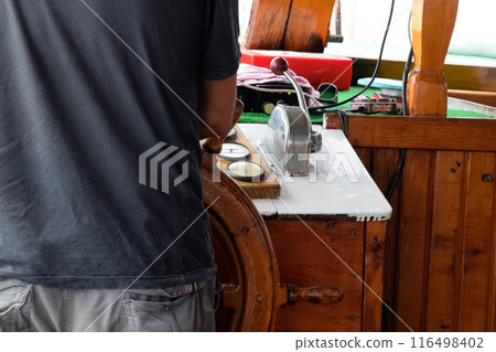 The captain of the ship at the helm The captain of the ship at the helm 116498402
