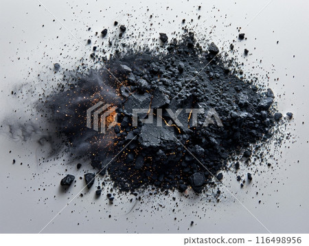 collection of gleaming black coal pieces rests dramatically on a pristine white surface, exuding a stark contrast of light and darkness. 116498956