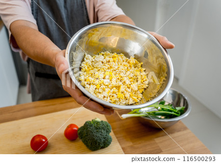 Chef at the kitchen preparing tofu scramble with vegetables Chef at the kitchen preparing tofu scramble with vegetables 116500293
