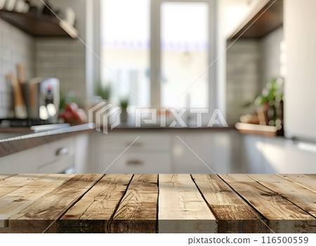 A blurred kitchen background with an empty wooden countertop 116500559