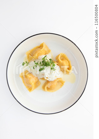 Ravioli with salmon on a white plate. Copy space. Isolated object. Top view. 116500804