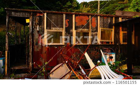 An old, abandoned cafe and its dilapidated structure 116501155