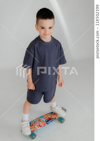 Full body little small smiling happy boy 5-6 years old wearing grey t-shirt look camera isolated on background studio Mother's Day love family lifestyle concept Full body little small smiling happy boy 5-6 years old wearing grey t-shirt look camera isolated on background studio Mother's Day love family lifestyle concept 116502399