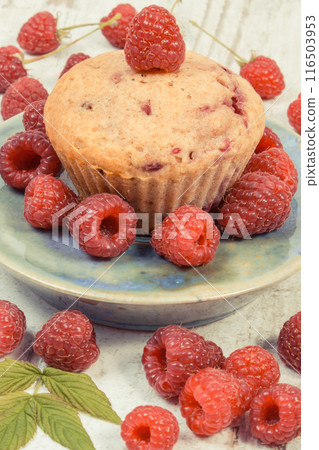 Fresh baked muffin with raspberries and chocolate. Delicious dessert for different occasion 116503953