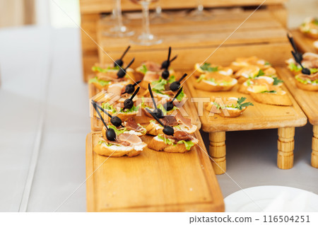 A large selection of food and various snacks at the buffet for guests before the event A large selection of food and various snacks at the buffet for guests before the event 116504251