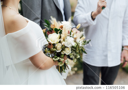 nice wedding bouquet in bride's hand 116505106