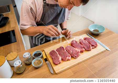 Raw fillet beef meat for steaks on the home electric grill Raw fillet beef meat for steaks on the home electric grill 116505440