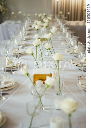 Elegant neutral coloured wedding table scape with flowers and candles Elegant neutral coloured wedding table scape with flowers and candles 116505619