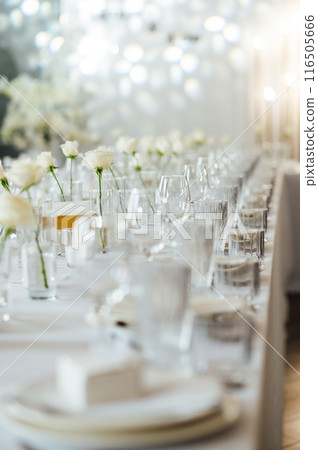 Elegant neutral coloured wedding table scape with flowers and candles Elegant neutral coloured wedding table scape with flowers and candles 116505666