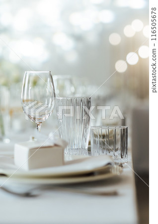 Elegant neutral coloured wedding table scape with flowers and candles Elegant neutral coloured wedding table scape with flowers and candles 116505678