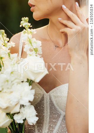 Beautiful bride in a sexy corset holds a beautiful bouquet 116505834