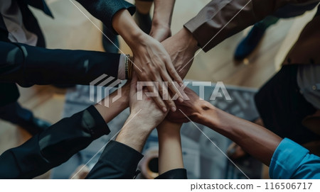 Diverse team of business professionals coming together in a spirit of teamwork and collaboration 116506717