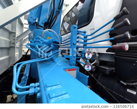 Truck featuring several blue buttons on its interface for crane control 116506718