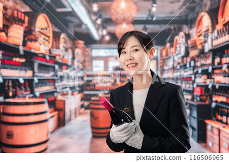 Female sommelier holding wine Female sommelier holding wine 116506965