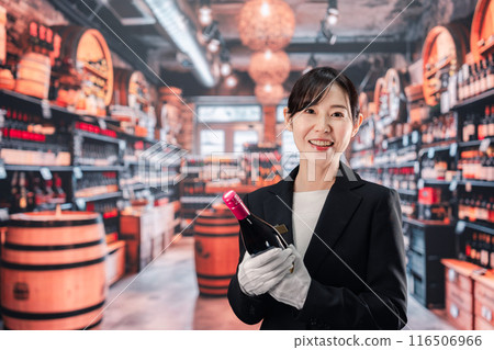 Female sommelier holding wine Female sommelier holding wine 116506966