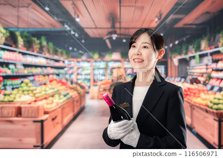 Female sommelier holding wine Female sommelier holding wine 116506971