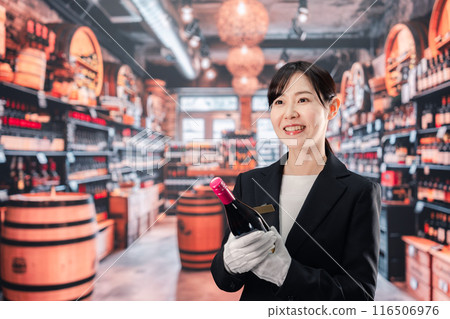Female sommelier holding wine Female sommelier holding wine 116506976