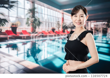 Young woman having fun in the pool Young woman having fun in the pool 116507724