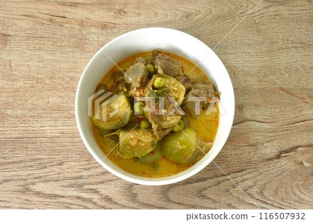 spicy boiled beef meat with eggplant in coconut milk red curry soup on bowl  116507932