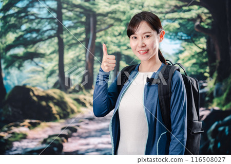 Woman climbing a mountain in sunny weather Woman climbing a mountain in sunny weather 116508027