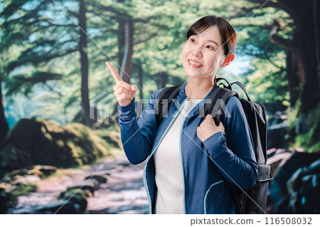 Woman climbing a mountain in sunny weather Woman climbing a mountain in sunny weather 116508032