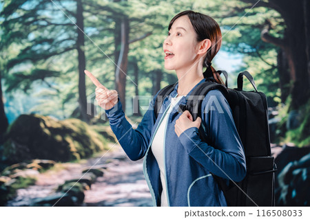 Woman climbing a mountain in sunny weather Woman climbing a mountain in sunny weather 116508033