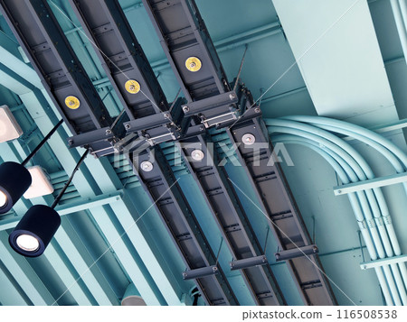 Ceiling with ventilation pipes and lights in industrial building Ceiling with ventilation pipes and lights in industrial building 116508538