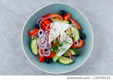 Apetite Greek salad in beautiful dishes for food delivery website menu on gray background. 116509214