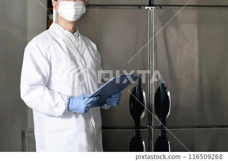 Asian man in sanitary clothes inspecting in kitchen Asian man in sanitary clothes inspecting in kitchen 116509268