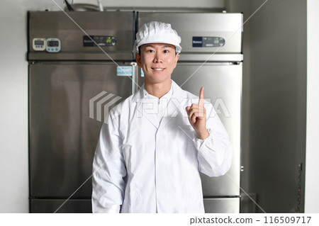 Asian man in sanitary clothes inspecting in kitchen Asian man in sanitary clothes inspecting in kitchen 116509717