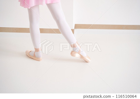 Young ballet girl at studio lesson. Training performance. Stretching exercise Young ballet girl at studio lesson. Training performance. Stretching exercise 116510064