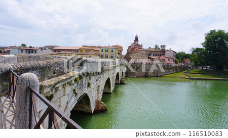 Historical roman Tiberius Bridge over Marecchia river in Rimini at Italy 116510083