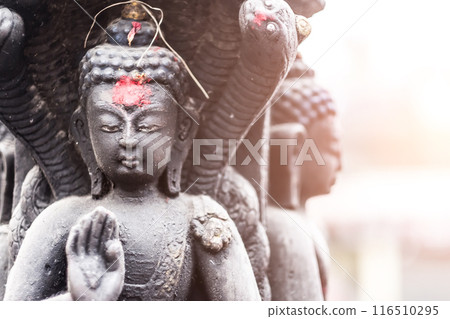 Buddha in a stone sculpture in Swayambhunath, Nepal 116510295