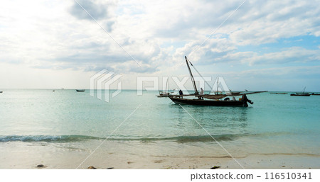 rustic fishing boat sitting in ocean, zanzibar rustic fishing boat sitting in ocean, zanzibar 116510341