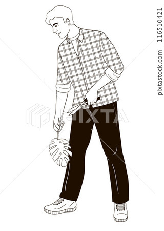 man with garden shears and a monstera leaf takes care of indoor plants 116510421