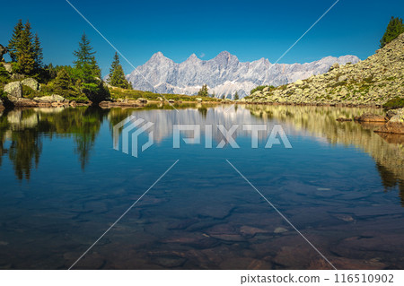 Stunning mountain lake and high mountain ridges in Austria Stunning mountain lake and high mountain ridges in Austria 116510902