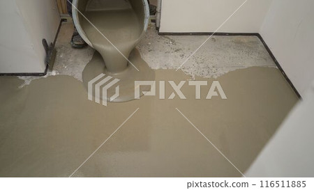 The self-leveling floor solution is poured onto the floor. A worker pours self-leveling solution to level the floor. Self-leveling floor. Floor leveling solution. The self-leveling floor solution is poured onto the floor. A worker pours self-leveling solution to level the floor. Self-leveling floor. Floor leveling solution. 116511885