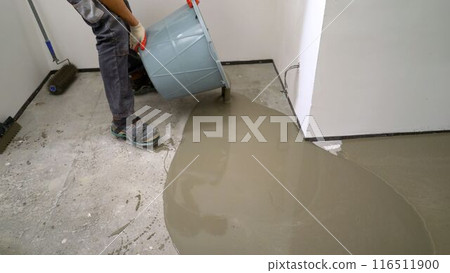 Floor renovation concept. Self-leveling floor is poured onto the floor, floor repair concept. Applying self leveling floor. Self-leveling floor. 116511900