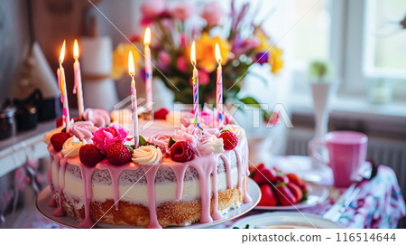 Birthday cake decorated with candles and flowers on the festive table with pink baloons. Selective focus 116514644