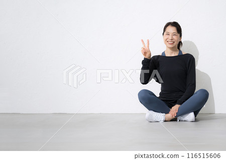Full body image of a woman who values exercise and health Peace sitting 116515606