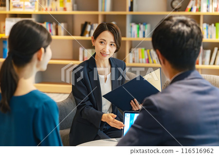 A couple and a counselor having a conversation in the lobby A couple and a counselor having a conversation in the lobby 116516962
